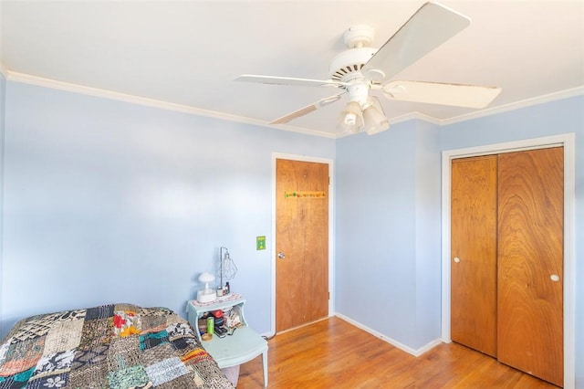 unfurnished bedroom featuring ceiling fan, a closet, light wood-type flooring, and ornamental molding