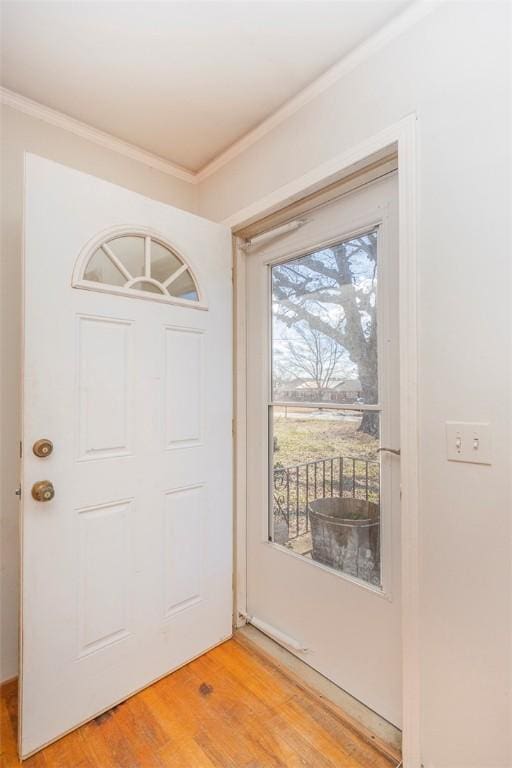 entryway featuring hardwood / wood-style floors and crown molding