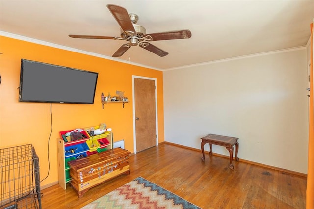 playroom with crown molding, ceiling fan, and hardwood / wood-style flooring