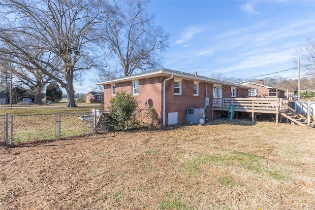 back of property featuring a yard and a wooden deck