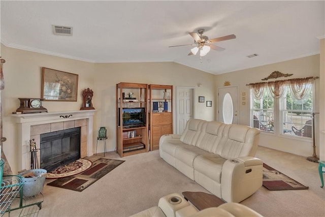 living room featuring light carpet, ceiling fan, lofted ceiling, and a tiled fireplace