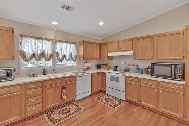 kitchen featuring sink, lofted ceiling, white appliances, light brown cabinetry, and light wood-type flooring