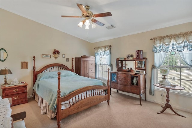 carpeted bedroom with multiple windows and ceiling fan