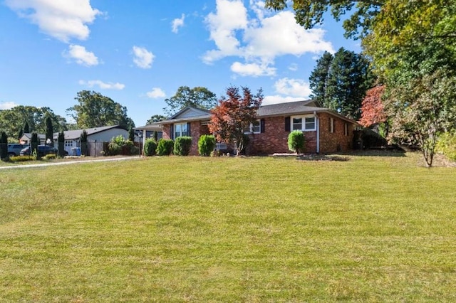 ranch-style home with a front lawn