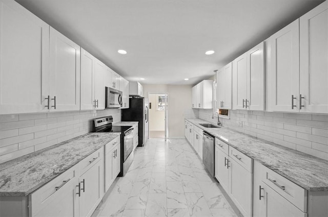 kitchen featuring white cabinetry and appliances with stainless steel finishes