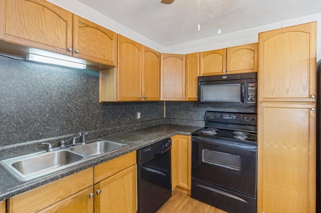 kitchen with black appliances, sink, light wood-type flooring, and backsplash