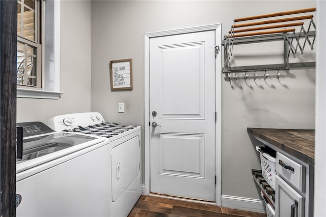 laundry area featuring washer and dryer and dark hardwood / wood-style flooring