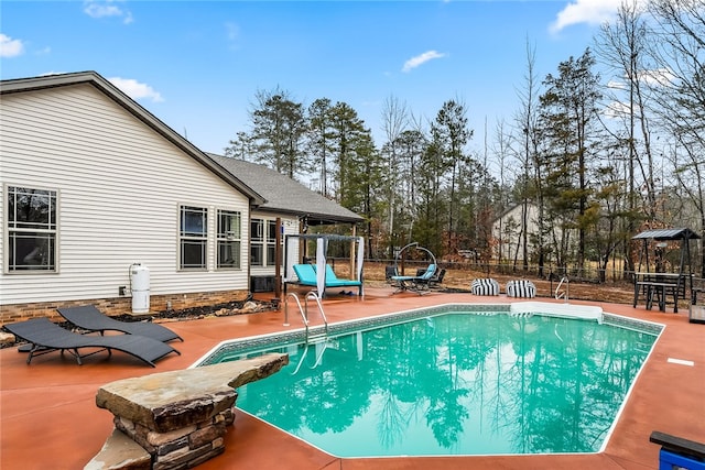 view of swimming pool featuring a patio area