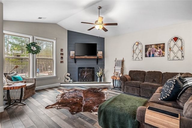 living room featuring a fireplace, wood-type flooring, ceiling fan, and lofted ceiling