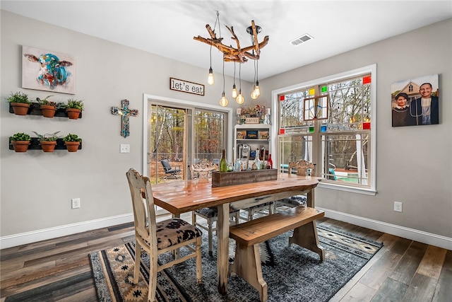 dining room with dark hardwood / wood-style flooring