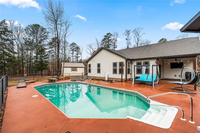 view of pool with ceiling fan and a patio area