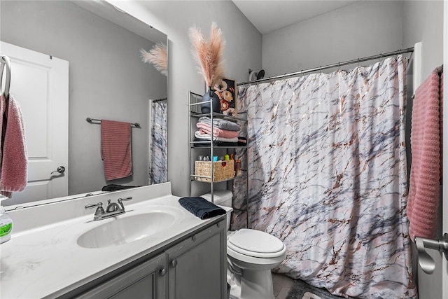 bathroom with vanity, toilet, and walk in shower