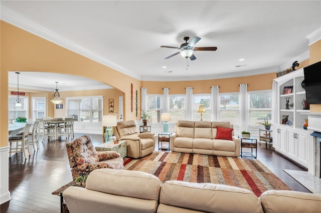 living room featuring dark hardwood / wood-style floors, ceiling fan, and ornamental molding