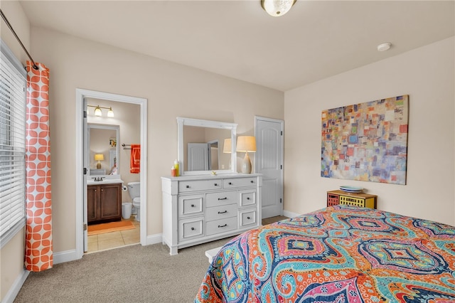 bedroom featuring light colored carpet, sink, and connected bathroom