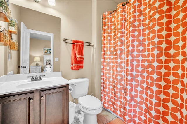 bathroom featuring tile patterned floors, vanity, and toilet