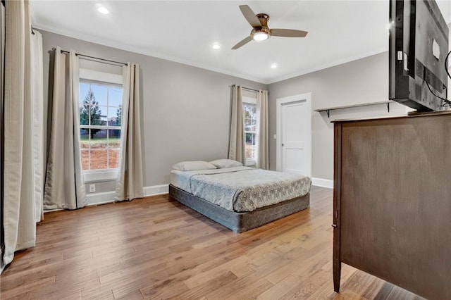 bedroom featuring light wood-type flooring, ceiling fan, and crown molding