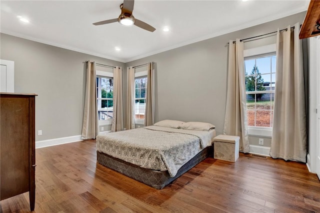 bedroom featuring ceiling fan, hardwood / wood-style floors, and ornamental molding