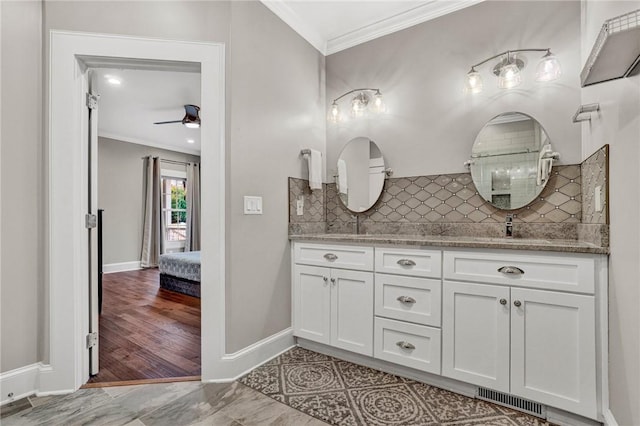 bathroom with vanity, backsplash, ceiling fan, and crown molding