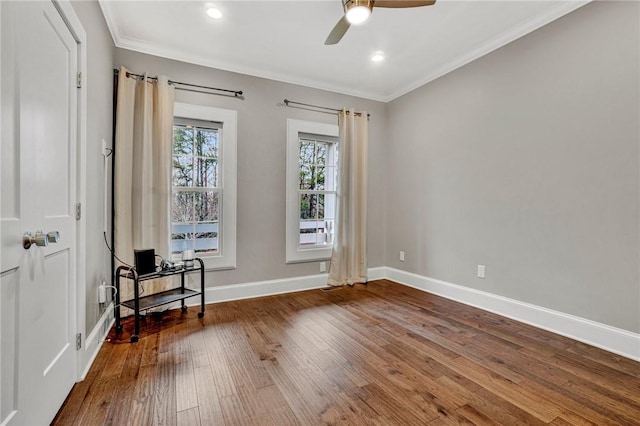 empty room with hardwood / wood-style floors, ceiling fan, and crown molding