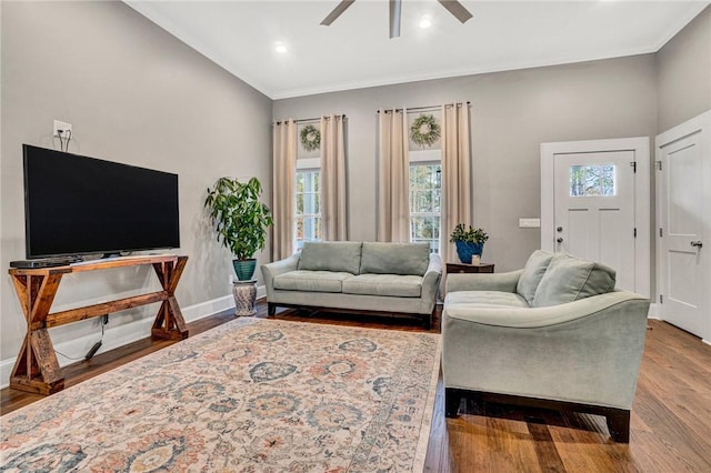 living room with hardwood / wood-style flooring, ceiling fan, and crown molding