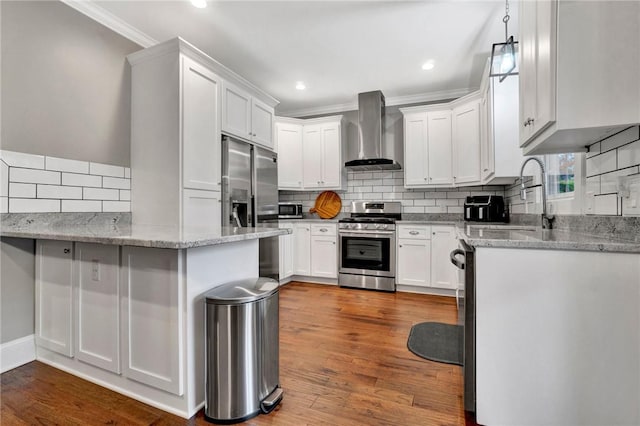 kitchen featuring white cabinetry, sink, wall chimney exhaust hood, light stone counters, and appliances with stainless steel finishes