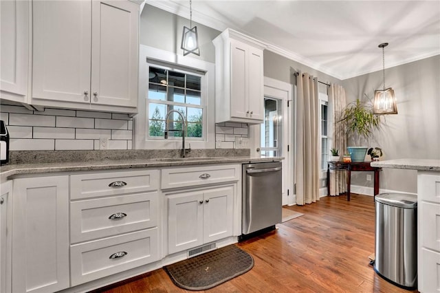 kitchen featuring dishwasher, white cabinets, pendant lighting, and sink