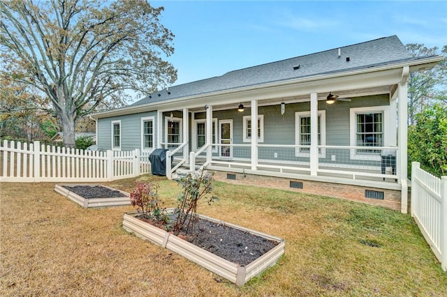 rear view of property featuring a lawn, ceiling fan, and covered porch