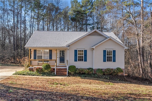 ranch-style home with a porch and a front lawn