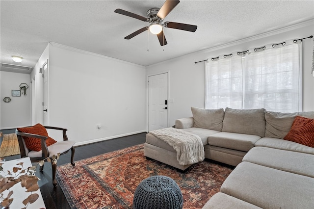 living room featuring a textured ceiling, crown molding, ceiling fan, and dark wood-type flooring