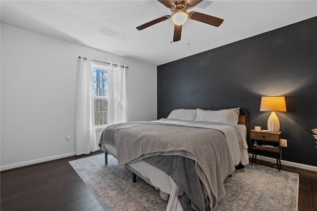 bedroom featuring a textured ceiling, ceiling fan, and dark hardwood / wood-style floors