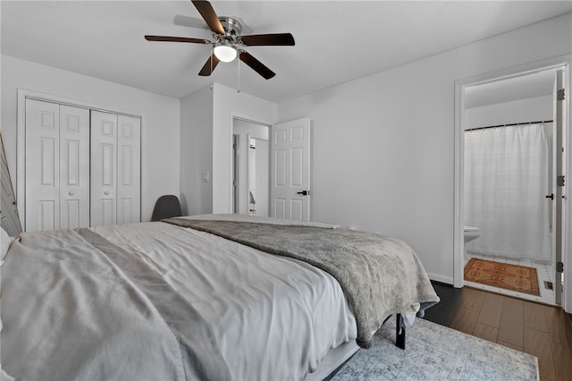 bedroom with ensuite bath, ceiling fan, a closet, and dark hardwood / wood-style floors