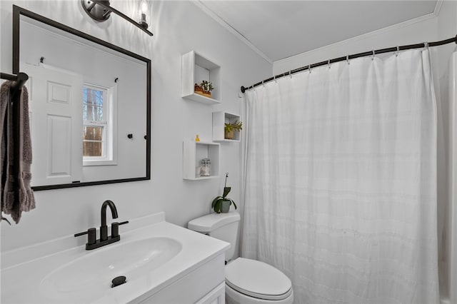 bathroom with vanity, toilet, and ornamental molding