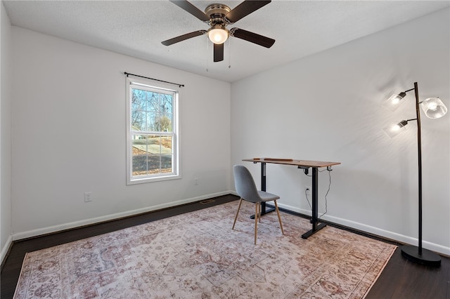 office featuring dark hardwood / wood-style floors and ceiling fan