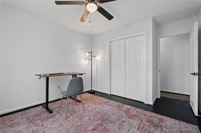 office with ceiling fan and dark hardwood / wood-style flooring