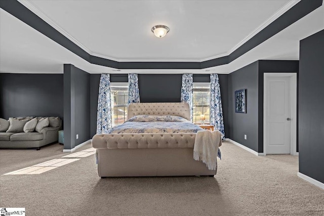 carpeted bedroom featuring a raised ceiling and ornamental molding