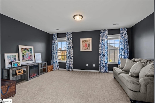 sitting room featuring carpet flooring and plenty of natural light