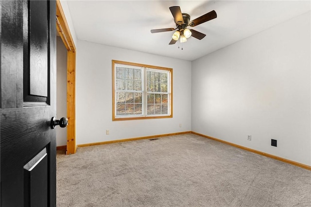 empty room featuring light carpet and ceiling fan