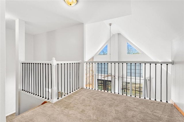 bonus room with carpet flooring and high vaulted ceiling