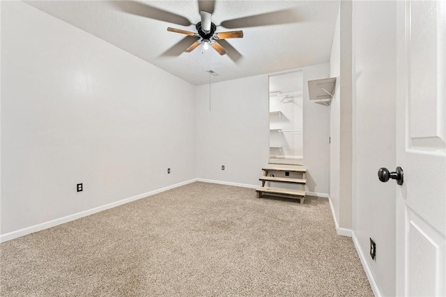 unfurnished room with ceiling fan and carpet flooring