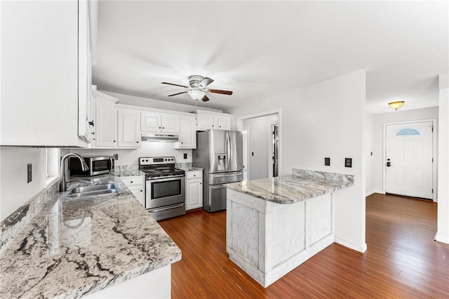 kitchen with dark wood-type flooring, sink, stainless steel appliances, light stone countertops, and white cabinets