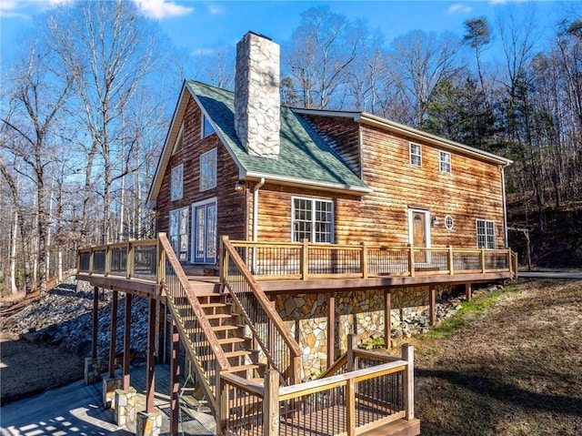 back of house featuring a patio and a deck