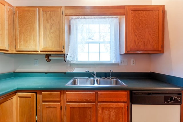 kitchen featuring a wealth of natural light, sink, and white dishwasher