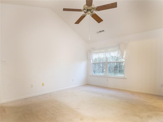 carpeted empty room with ceiling fan and high vaulted ceiling