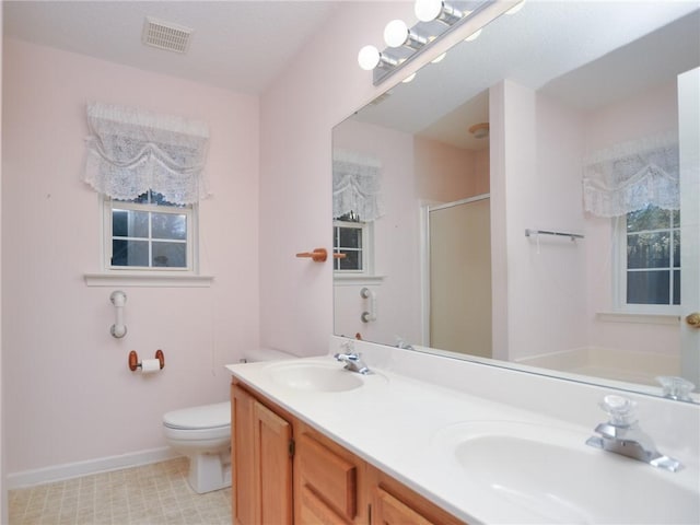 bathroom with vanity, an enclosed shower, and toilet