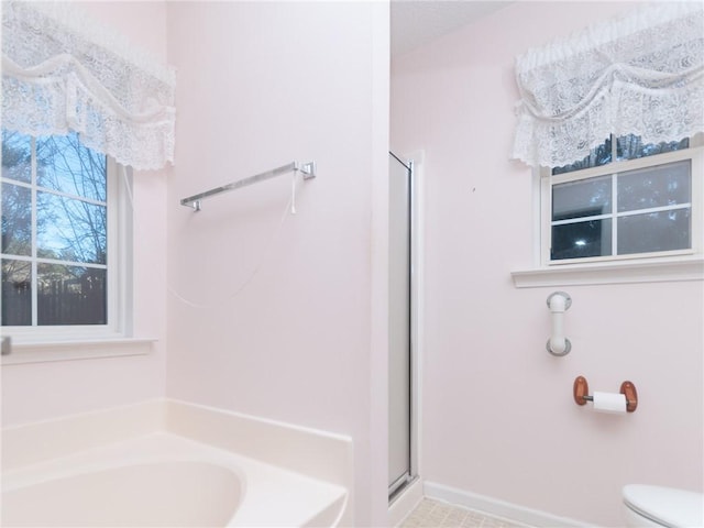 bathroom featuring plus walk in shower and toilet