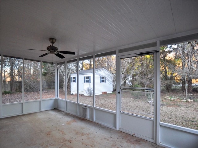 unfurnished sunroom with ceiling fan