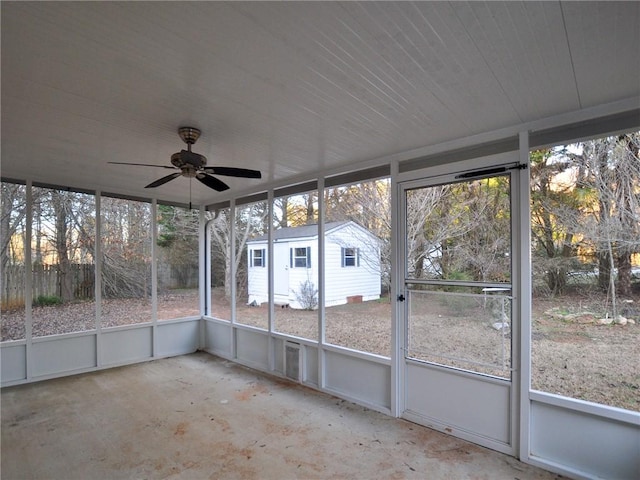 unfurnished sunroom featuring ceiling fan