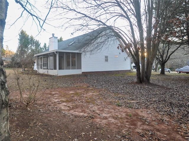 view of side of home with a sunroom