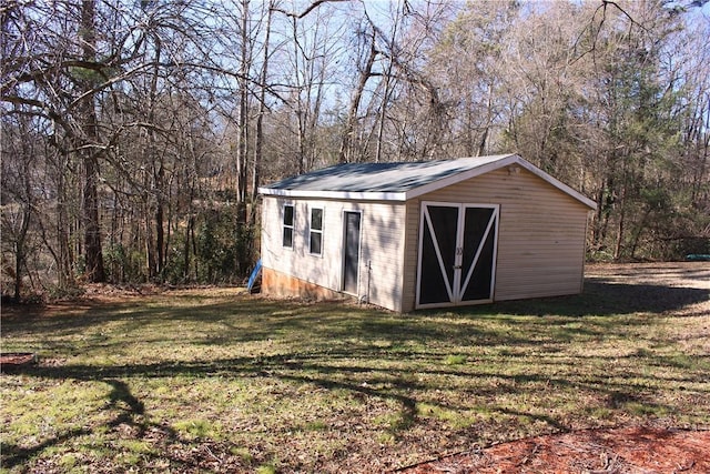 view of outbuilding featuring a yard