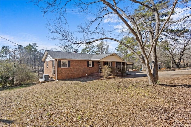 rear view of house featuring central AC